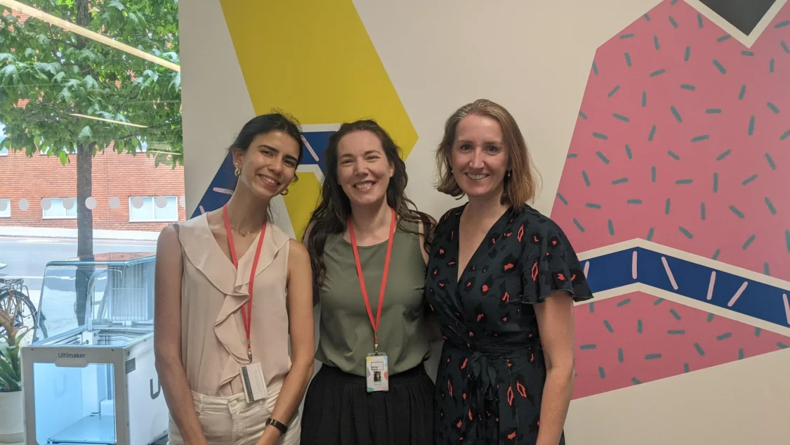 Ana, Aoife and Carly from Opportunity Green in front of a colourful wall mural