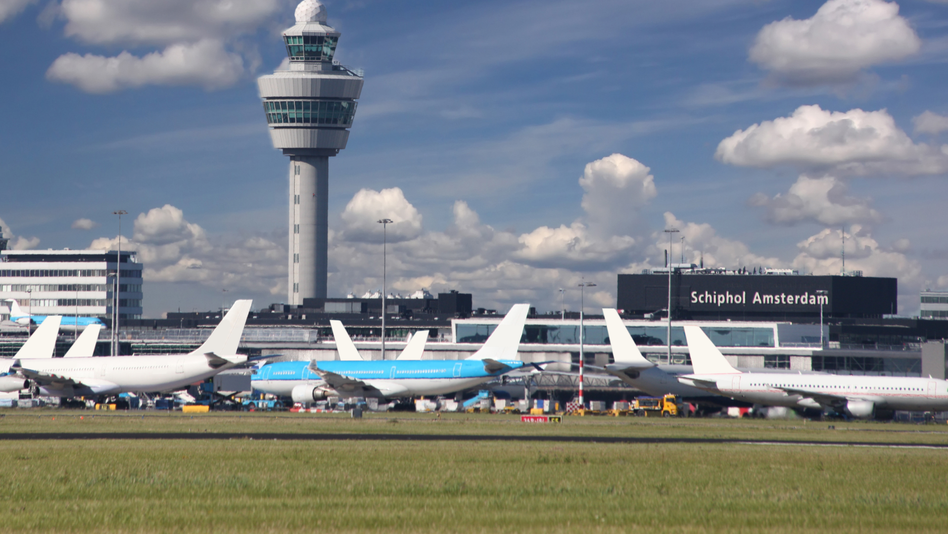 Shiphol Airport from the distance planes on ground and main sign visible Shiphol Airport from the distance planes on ground and main sign visible