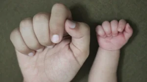 One big hand and one small child's hand