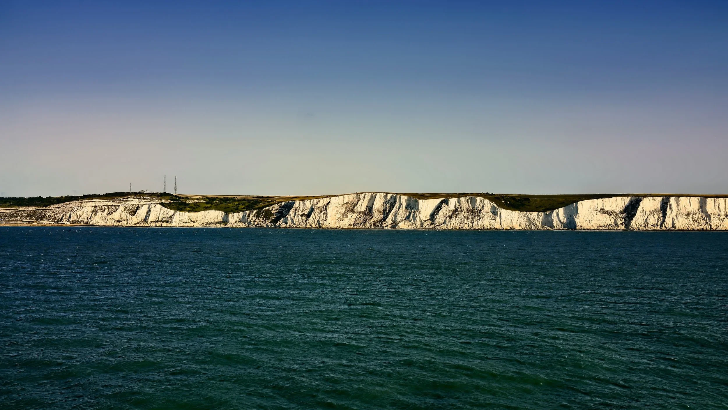 Cliff shoreline with ocean in foreground Cliff shoreline with ocean in foreground