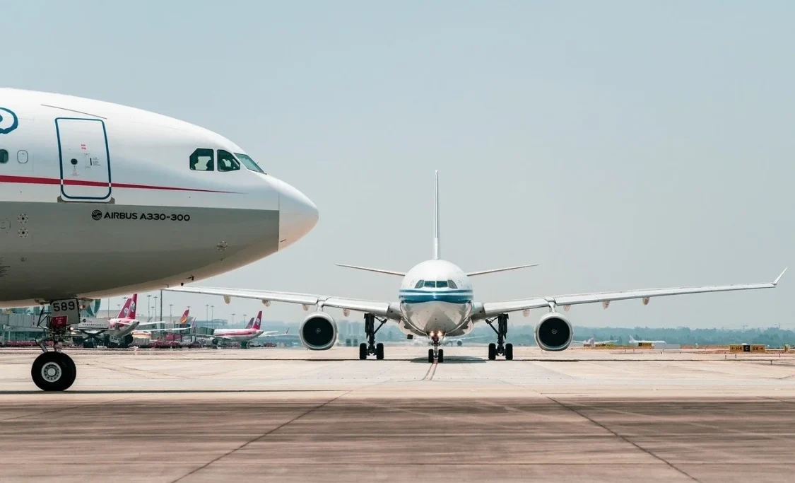 Image of two airplanes on a runway.