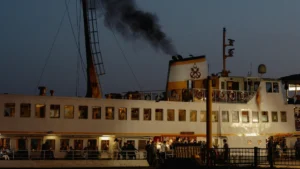 Close up of large cruise ship emitting waste from and polluting with LNG