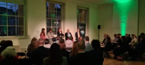 People sat on a stage facing audience