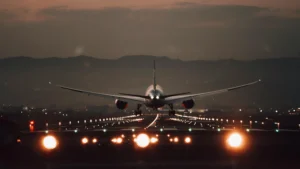 jet plane taking off from the back lights on the tracks