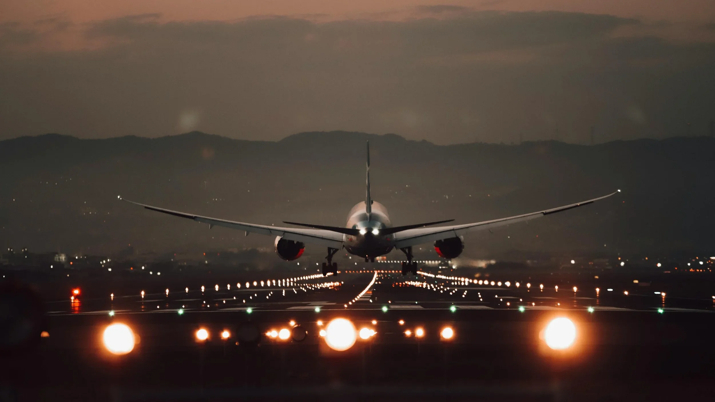 jet plane taking off from the back lights on the tracks