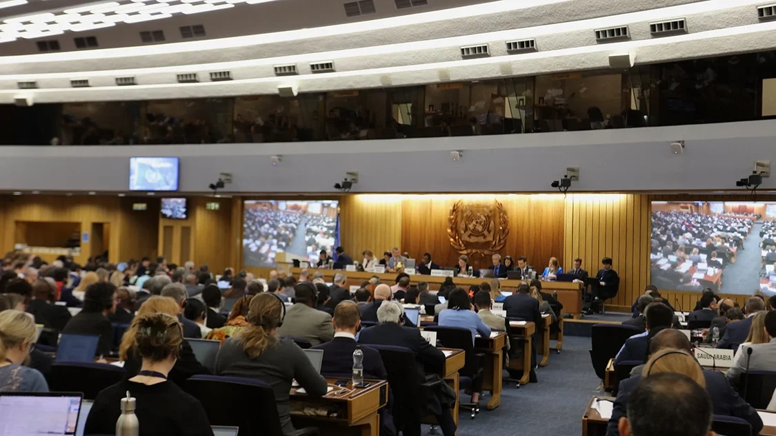People in suits sitting in the plenary of the International Maritime Organization (IMO) in London at climate change negotiations.