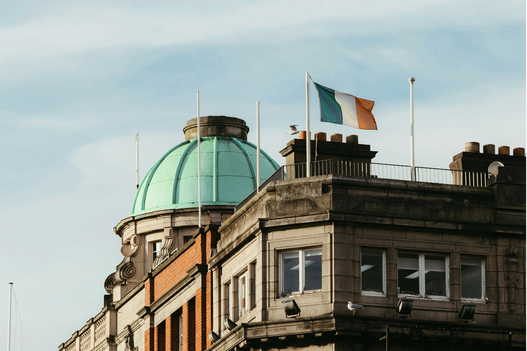 Closeup of The Custom House green dome in Dublin, Ireland with the Irish flag