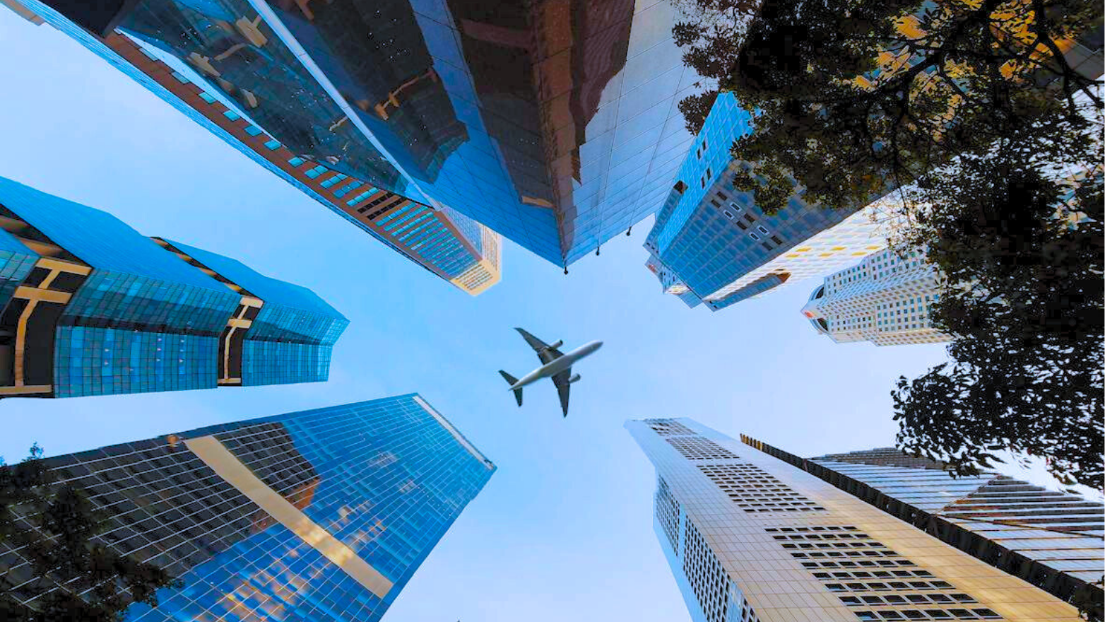 A jet plane soaring above skyscrapers