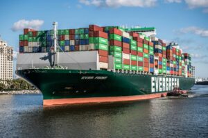 A cargo ship called 'Evergreen' laden with green and red containers