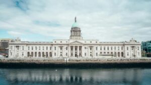 Main facade of Irish government buildings consisting of pillars and a green-domed roof