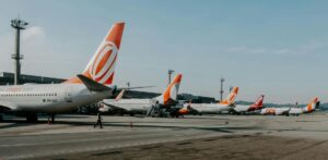 A row of aeroplanes with orange and white rudders waiting at a European airport