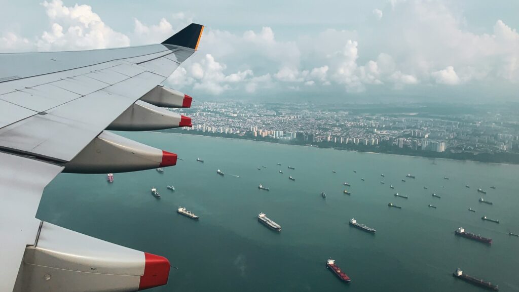 Airplane over ships