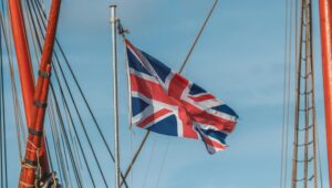 Union Jack flag in sky, surrounded by shipping masts