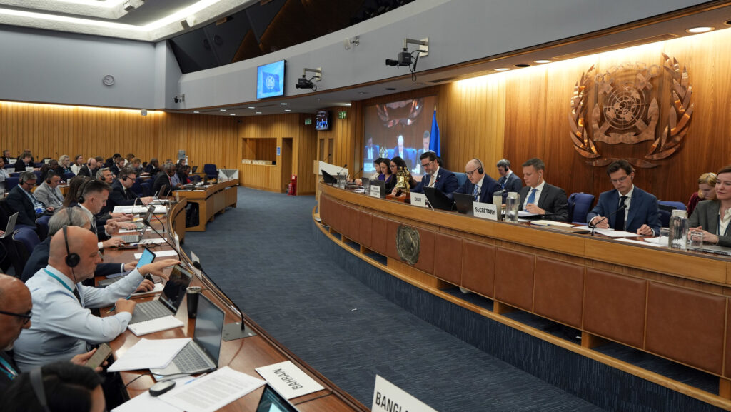 People sat on panel in negotiation room of the International Maritime Organization.