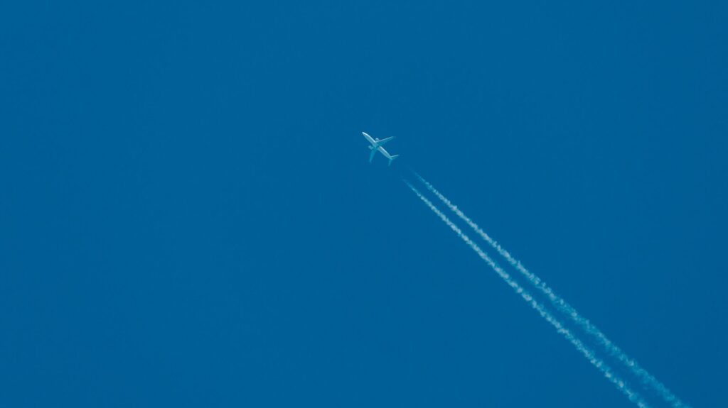 Plane leaving contrails behind it in the sky