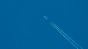 Plane leaving contrails behind it in the sky