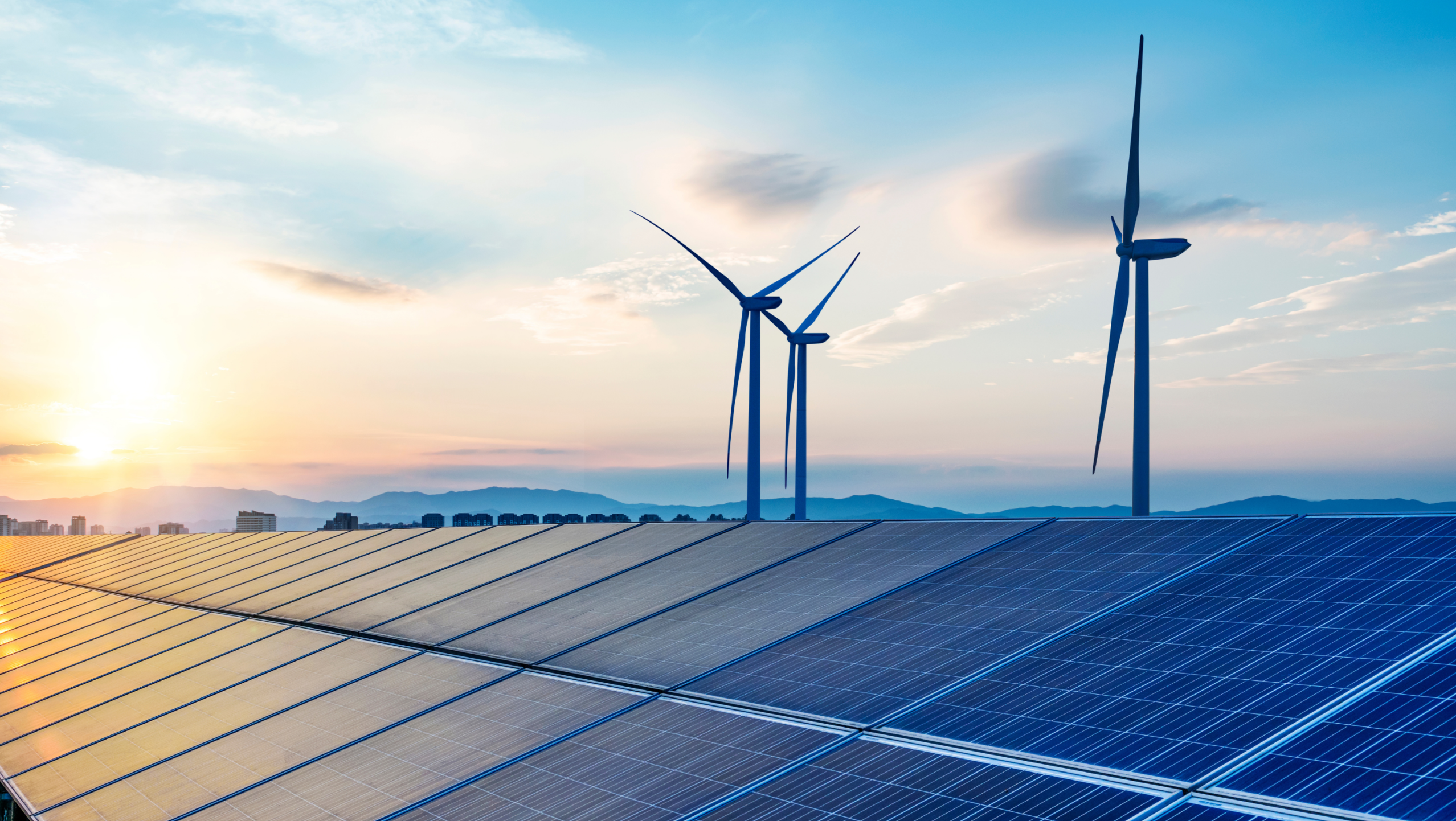 Solar panels and wind turbines against blue sky Solar panels and wind turbines against blue sky