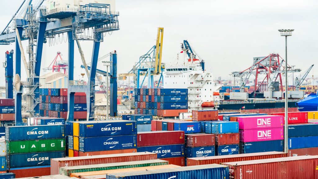 Ship with colourful containers of cargo in foreground.