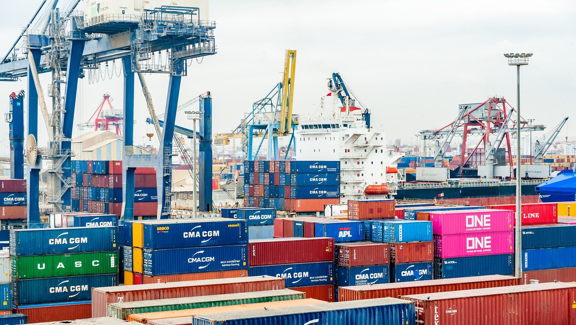 Ship with colourful containers of cargo in foreground.