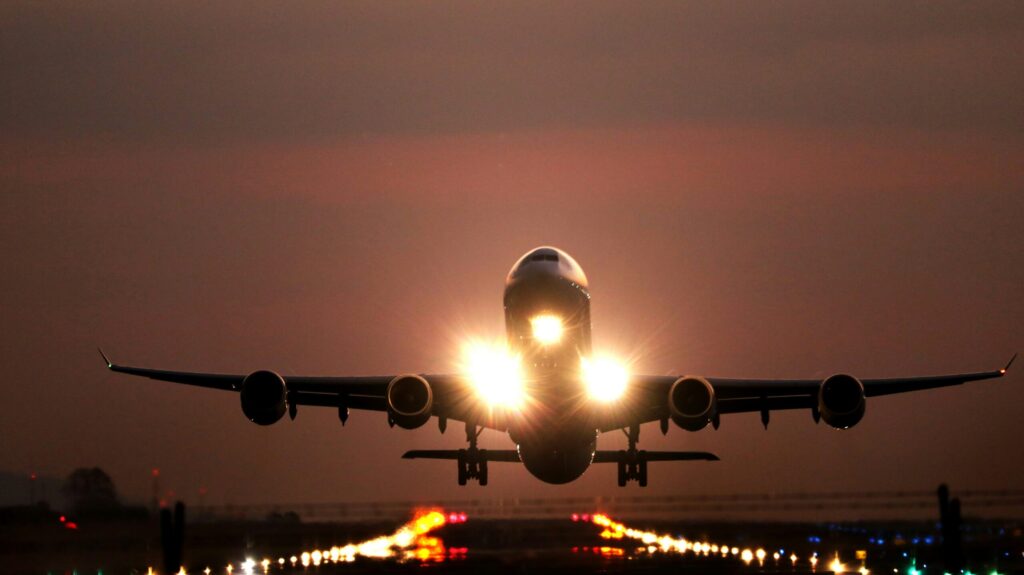 Night time ground view of an airplane taking off